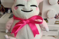 Pink Snorlax plush with ribbon