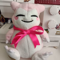 Pink Snorlax plush with ribbon